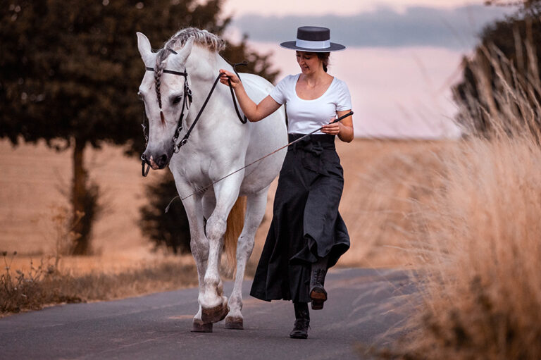 Rider contributes riding skirt Hedy doing manual work with her white horse Picadera